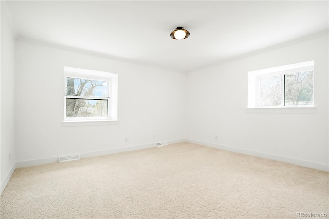 6325 W Portland Pl, Littleton, CO 80128 - spare room with healthy amount of natural light, light colored carpet, and baseboards