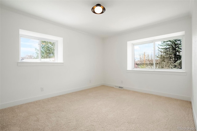 6325 W Portland Pl, Littleton, CO 80128 - unfurnished room featuring healthy amount of natural light, carpet flooring, and baseboards