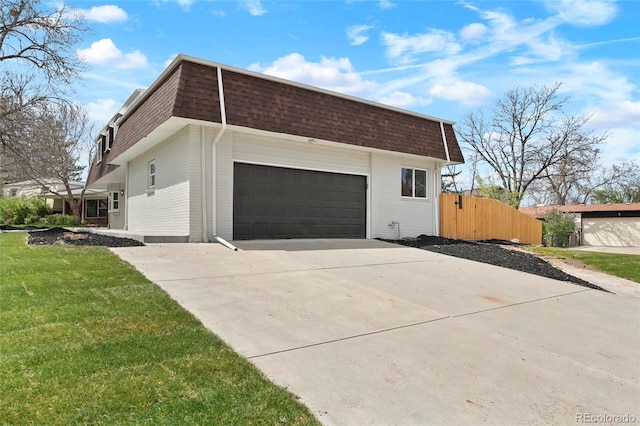 6325 W Portland Pl, Littleton, CO 80128 - view of side of property with mansard roof, brick siding, roof with shingles, and concrete driveway
