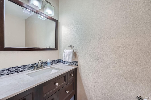 bathroom with vanity and tasteful backsplash