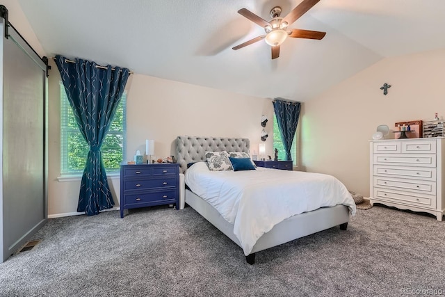 bedroom with ceiling fan, vaulted ceiling, and dark colored carpet