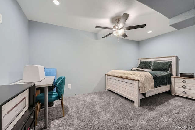 bedroom with ceiling fan and dark carpet