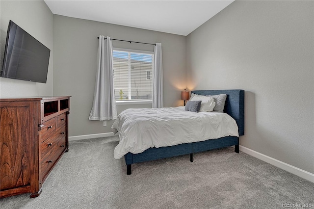 bedroom featuring carpet and baseboards