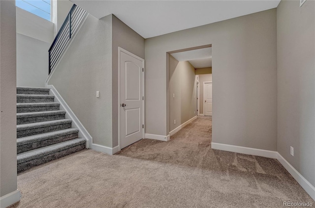 stairs featuring baseboards and carpet floors