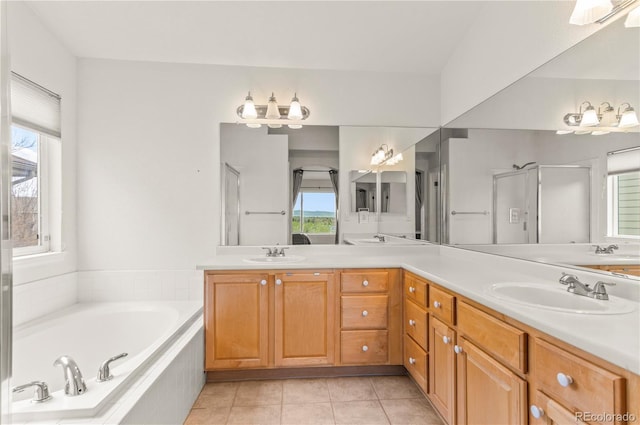 full bathroom featuring a garden tub, double vanity, a stall shower, and tile patterned floors