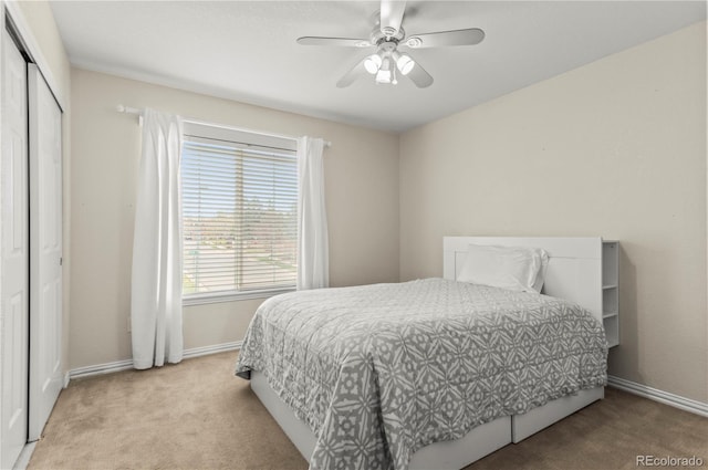 carpeted bedroom featuring baseboards, a closet, and a ceiling fan