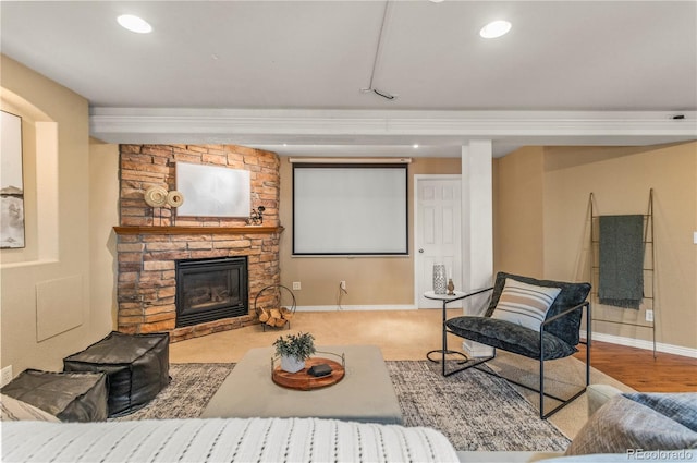 living room with baseboards, a fireplace, and recessed lighting