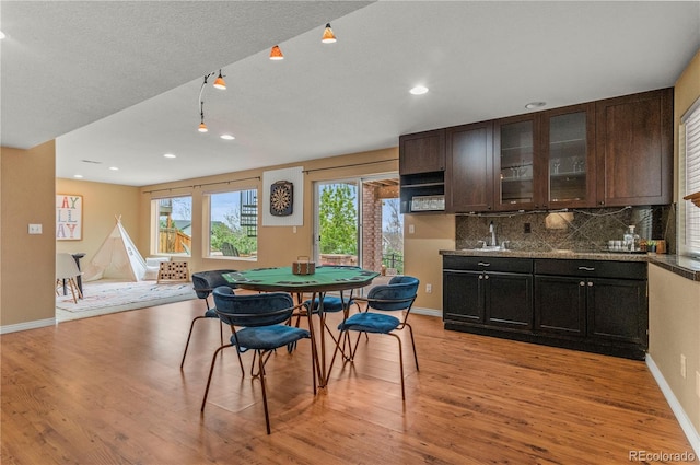 dining space with light wood-style floors, baseboards, and recessed lighting