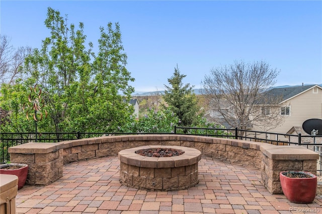 view of patio / terrace featuring a fire pit and fence