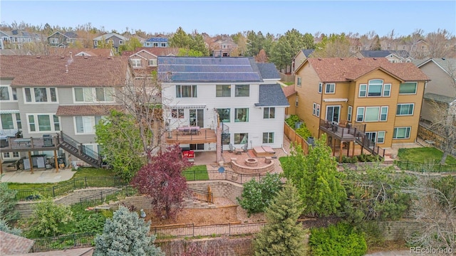 rear view of property with a residential view, stairs, and a fenced backyard