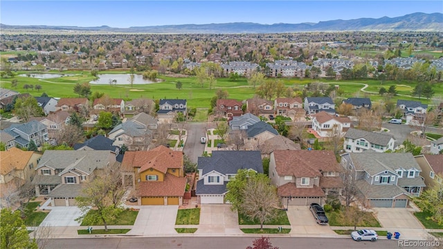 aerial perspective of suburban area featuring a golf club and a water and mountain view