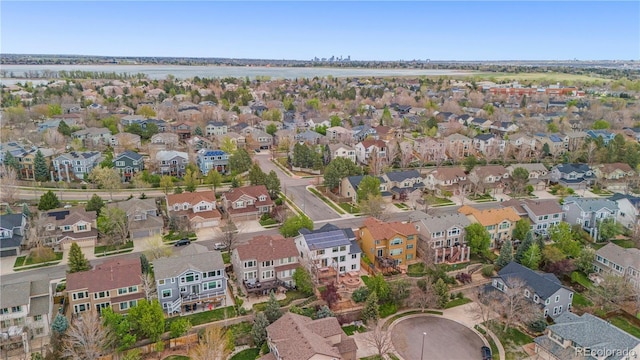 aerial view of property's location with nearby suburban area and a large body of water