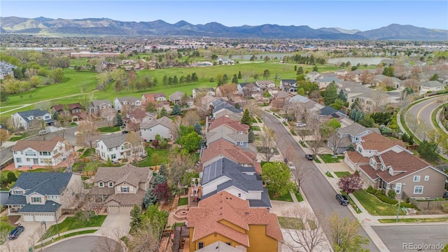 view of property location featuring nearby suburban area, a water and mountain view, and a golf club
