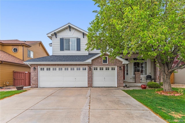 traditional home featuring driveway, brick siding, a garage, a shingled roof, and a front lawn