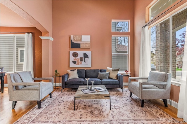 living area with wood finished floors and baseboards