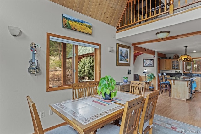 12191 Tecumseh Trl, Conifer, CO 80433 - dining room featuring vaulted ceiling, light wood finished floors, wood ceiling, and baseboards