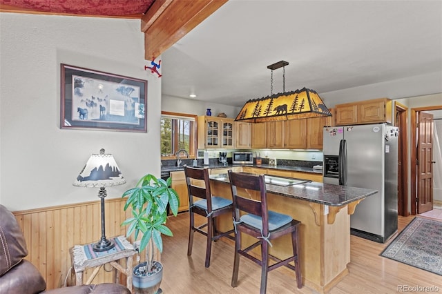 12191 Tecumseh Trl, Conifer, CO 80433 - kitchen featuring stainless steel appliances, light wood-type flooring, a kitchen breakfast bar, glass insert cabinets, and a sink