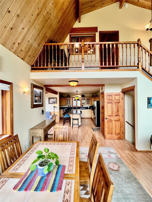 12191 Tecumseh Trl, Conifer, CO 80433 - dining area featuring high vaulted ceiling and light wood-style flooring