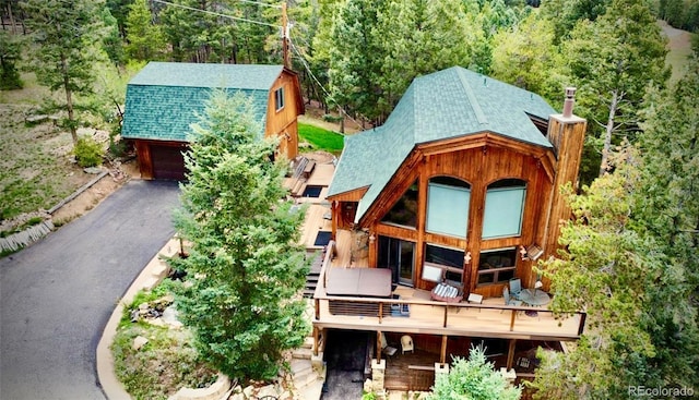 12191 Tecumseh Trl, Conifer, CO 80433 - back of house featuring a shingled roof, a chimney, a forest view, and a gambrel roof