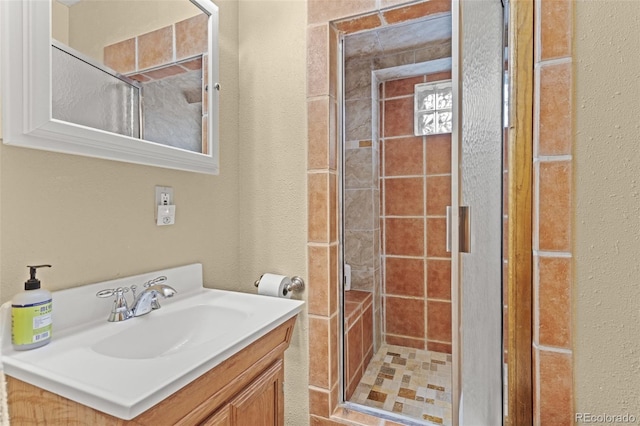 12191 Tecumseh Trl, Conifer, CO 80433 - bathroom featuring vanity, a stall shower, and a textured wall