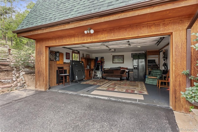 12191 Tecumseh Trl, Conifer, CO 80433 - garage with black fridge with ice dispenser