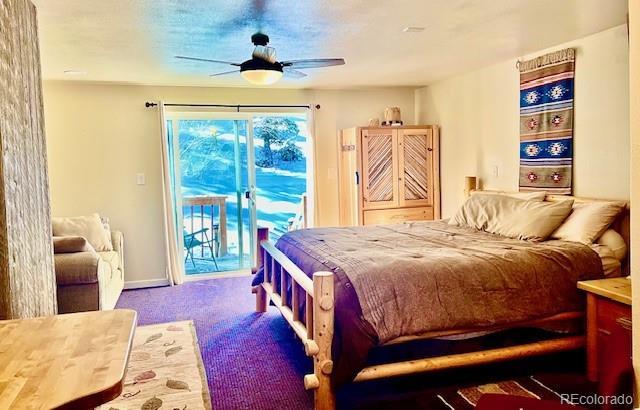 12191 Tecumseh Trl, Conifer, CO 80433 - carpeted bedroom featuring access to exterior and ceiling fan