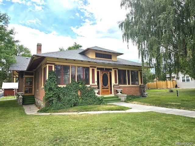 243 Park Ave, Salida, CO 81201 - view of front of house featuring a chimney, brick siding, and a shingled roof