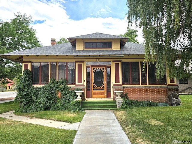 243 Park Ave, Salida, CO 81201 - bungalow with a front lawn, a sunroom, a chimney, and roof with shingles