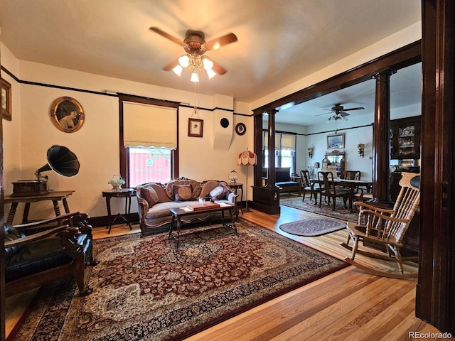243 Park Ave, Salida, CO 81201 - living area featuring ornate columns, a ceiling fan, and wood finished floors