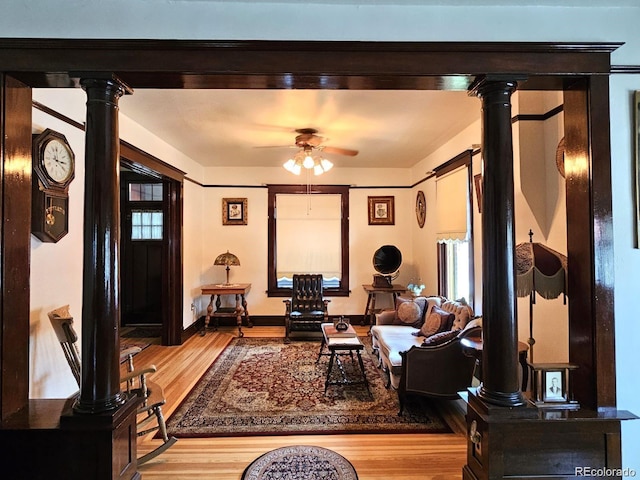 243 Park Ave, Salida, CO 81201 - living room featuring ornate columns, wood finished floors, ceiling fan, and plenty of natural light