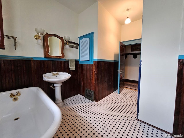 243 Park Ave, Salida, CO 81201 - bathroom with a wainscoted wall, a freestanding tub, and wooden walls