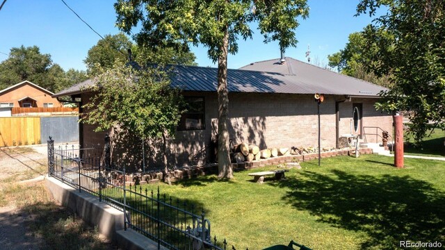 243 Park Ave, Salida, CO 81201 - back of house featuring a metal roof and concrete block siding