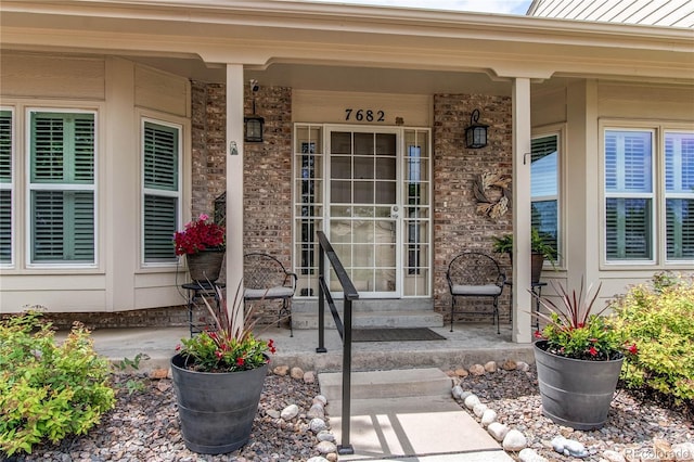 7682 S Cove Cir, Centennial, CO 80122 - entrance to property with a porch and brick siding