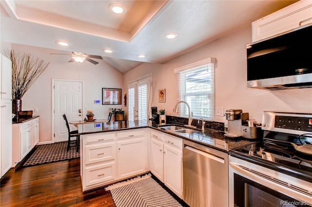 7682 S Cove Cir, Centennial, CO 80122 - kitchen featuring appliances with stainless steel finishes, a sink, a peninsula, dark stone countertops, and recessed lighting