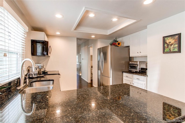 7682 S Cove Cir, Centennial, CO 80122 - kitchen with stainless steel fridge, black microwave, a sink, white cabinetry, and recessed lighting