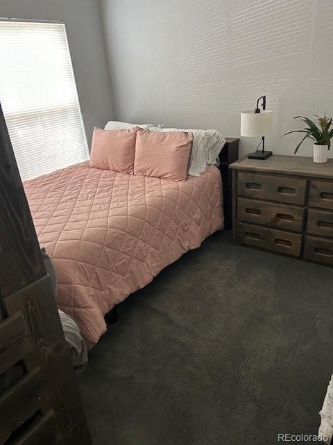 bedroom featuring dark colored carpet