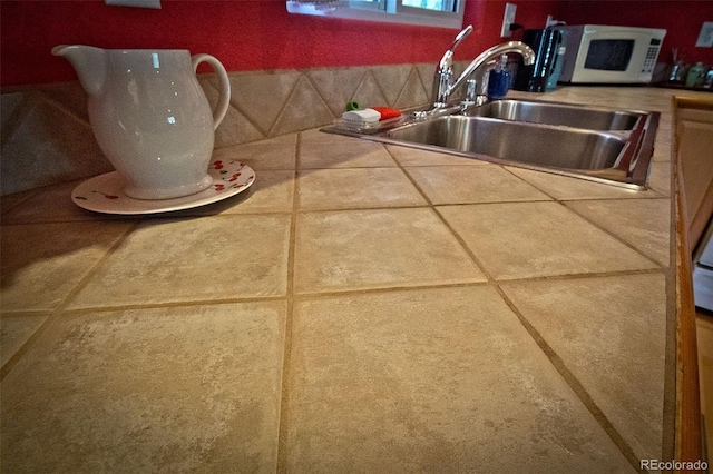 3713 Enchanted Way, Crestone, CO 81131 - interior details with tile countertops, a sink, and white microwave