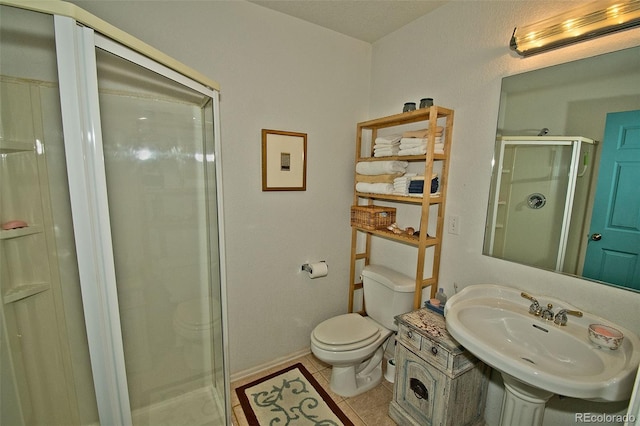 3713 Enchanted Way, Crestone, CO 81131 - bathroom featuring a sink, toilet, tile patterned floors, baseboards, and a stall shower