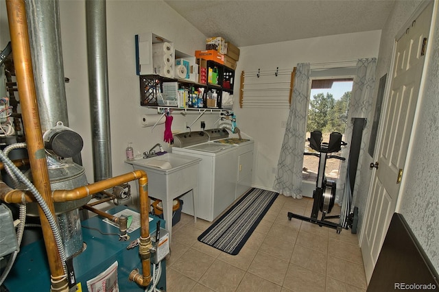 3713 Enchanted Way, Crestone, CO 81131 - clothes washing area with laundry area, washing machine and dryer, light tile patterned flooring, a textured ceiling, and a sink