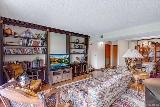 12565 Sheridan Blvd Unit 105, Broomfield, CO 80020 - living area featuring a textured ceiling, a chandelier, and wood finished floors