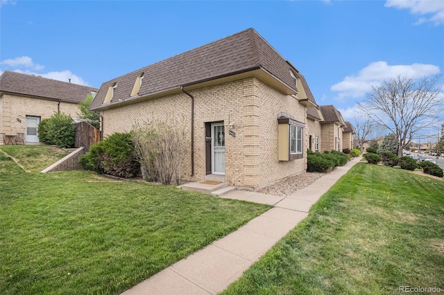 5573 S Lowell Blvd, Littleton, CO 80123 - view of side of property featuring mansard roof, a shingled roof, and brick siding