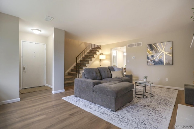 5573 S Lowell Blvd, Littleton, CO 80123 - living area featuring stairway, wood finished floors, and baseboards