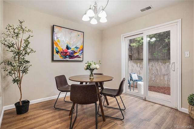 5573 S Lowell Blvd, Littleton, CO 80123 - dining space featuring a chandelier, wood finished floors, and baseboards