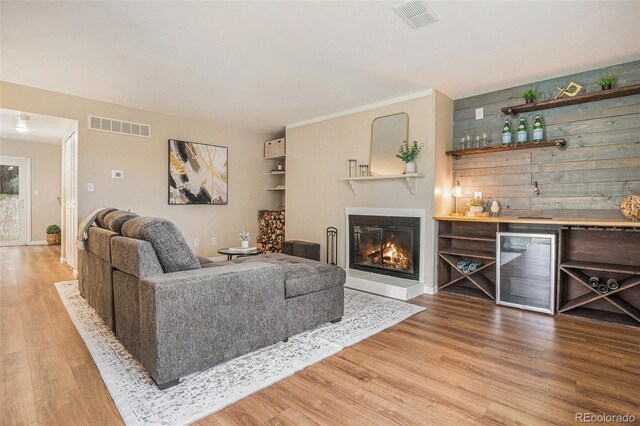 5573 S Lowell Blvd, Littleton, CO 80123 - living room with wine cooler, wood finished floors, a dry bar, and a glass covered fireplace