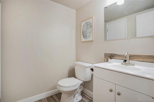 5573 S Lowell Blvd, Littleton, CO 80123 - half bath with toilet, baseboards, vanity, and wood finished floors
