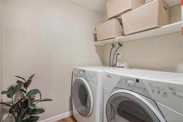 5573 S Lowell Blvd, Littleton, CO 80123 - laundry room featuring washer and clothes dryer, baseboards, and light wood-style flooring