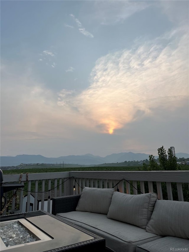 8695 Torrey St, Arvada, CO 80007 - deck at dusk featuring outdoor lounge area and a mountain view