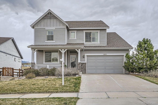 8695 Torrey St, Arvada, CO 80007 - craftsman house featuring covered porch, driveway, roof with shingles, board and batten siding, and fence