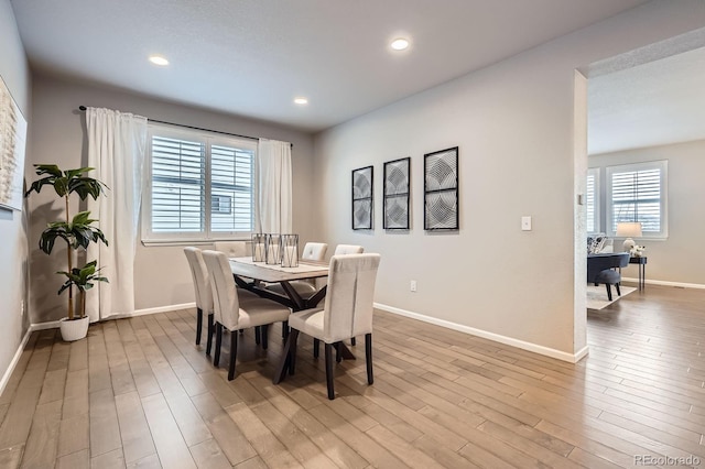 8695 Torrey St, Arvada, CO 80007 - dining space with light wood finished floors, baseboards, recessed lighting, and a desk