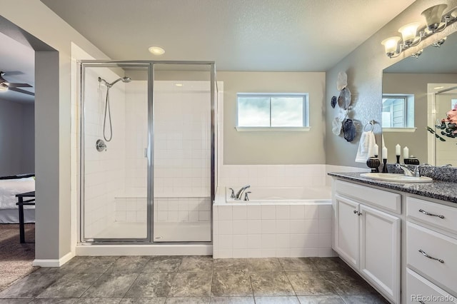 8695 Torrey St, Arvada, CO 80007 - bathroom with a shower stall, a bath, vanity, and ceiling fan